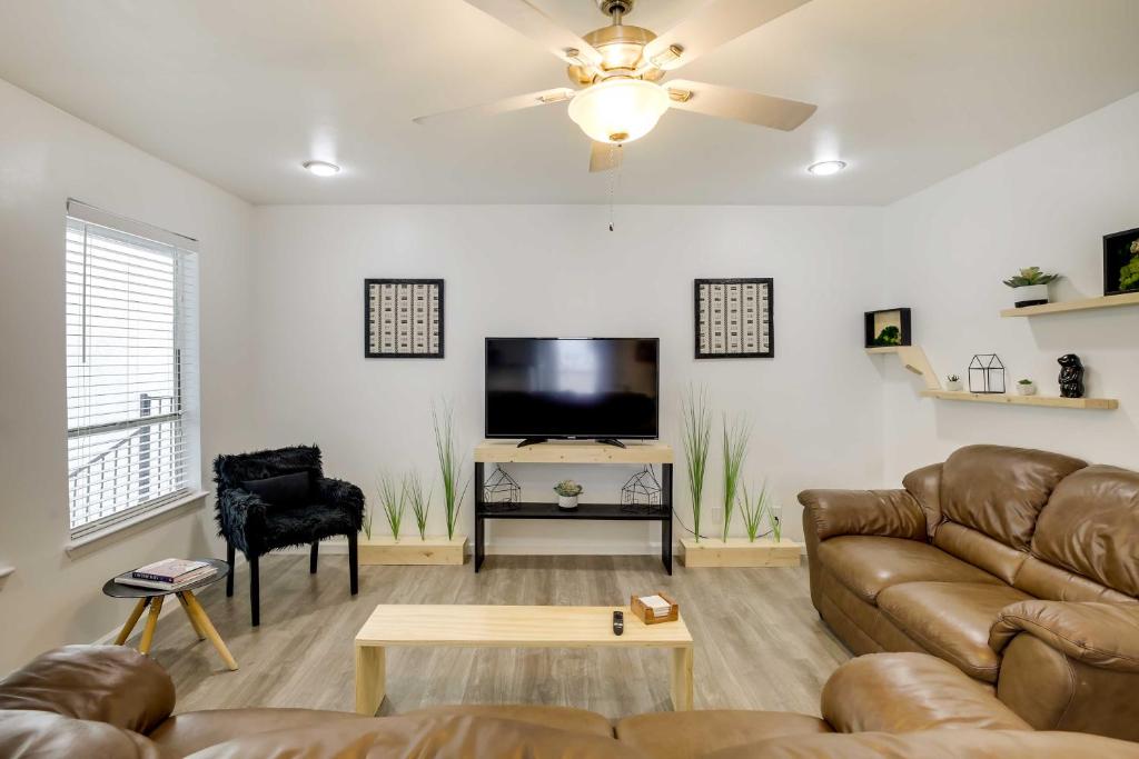 a living room with a couch and a flat screen tv at Serene Dallas Vacation Rental - Walkable Location! in Dallas