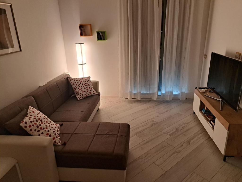 a living room with a couch and a television at Your Comfort Home - Bologna in Bologna