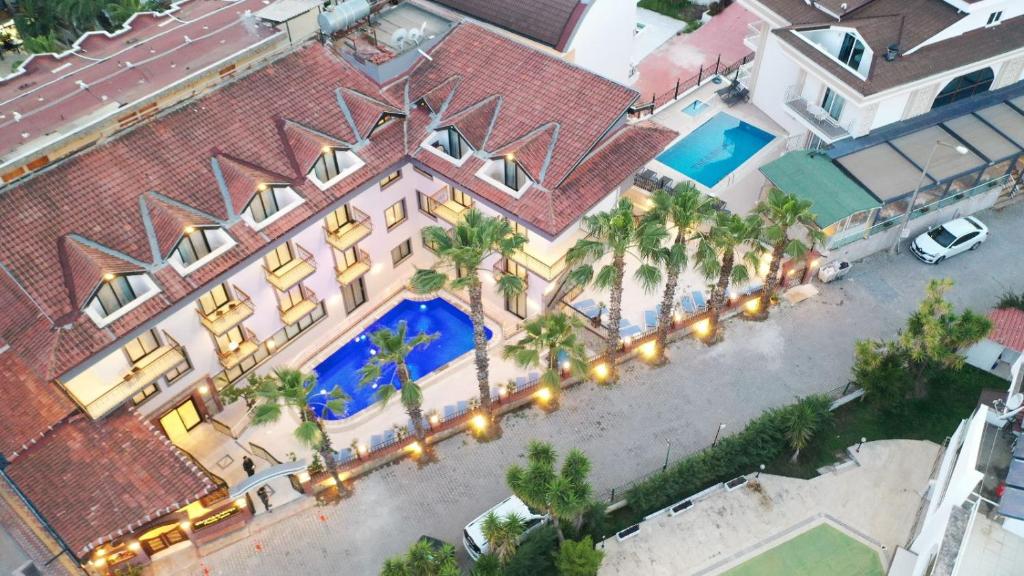 an overhead view of a large house with a swimming pool at Orange Garden Hotel in Kemer
