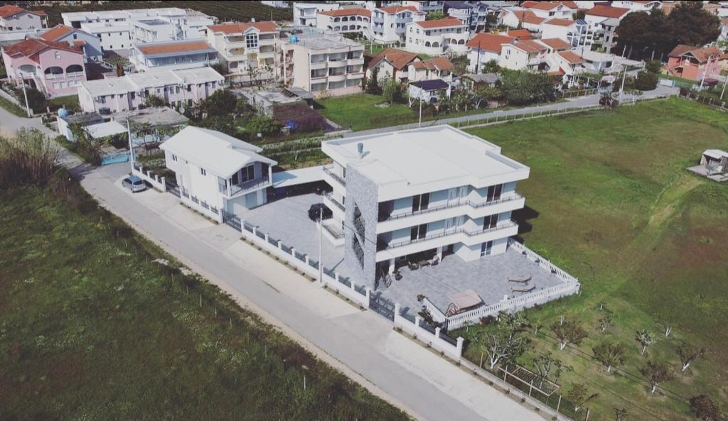 an aerial view of a white building in a city at FAMILY-FRIENDLY APARTMENTS in Donji Štoj