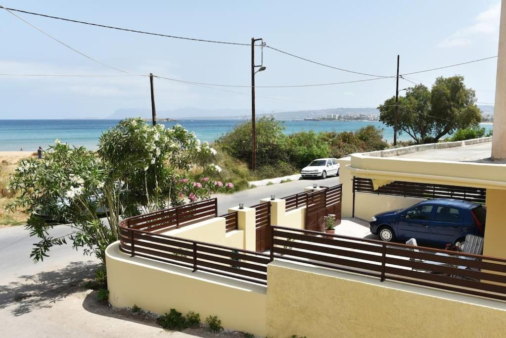 a car parked in front of a house with the ocean at Eleni's Σπίτι μπροστά στη θάλασσα in Daratso