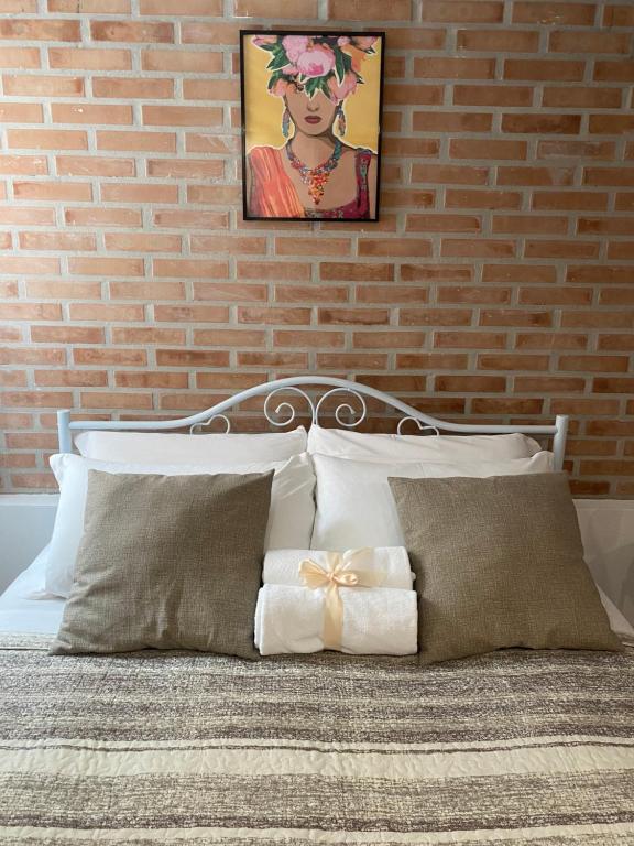 a bedroom with a bed with a brick wall at LAGUNA BLU Monolocale in Chioggia