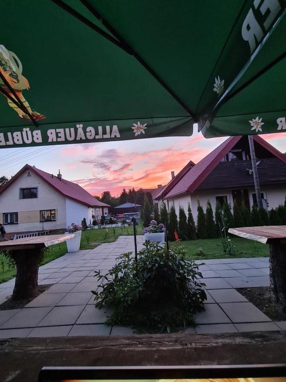 a view of a patio with a green umbrella at BL Beskydy Lodge in Prostřední Bečva