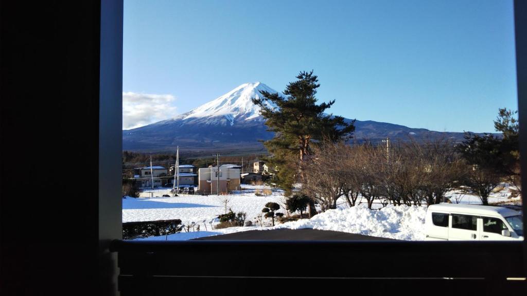 a view of a snow covered mountain from a window at KAINOSATO - Vacation STAY 08807v in Azagawa