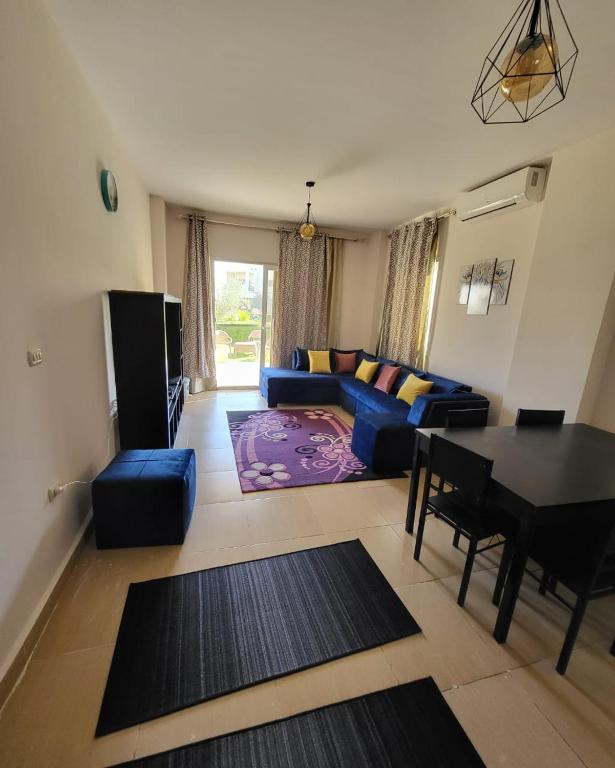 a living room with a blue couch and a table at Mousa Cost Resort عائلات فقط in Ras Sedr