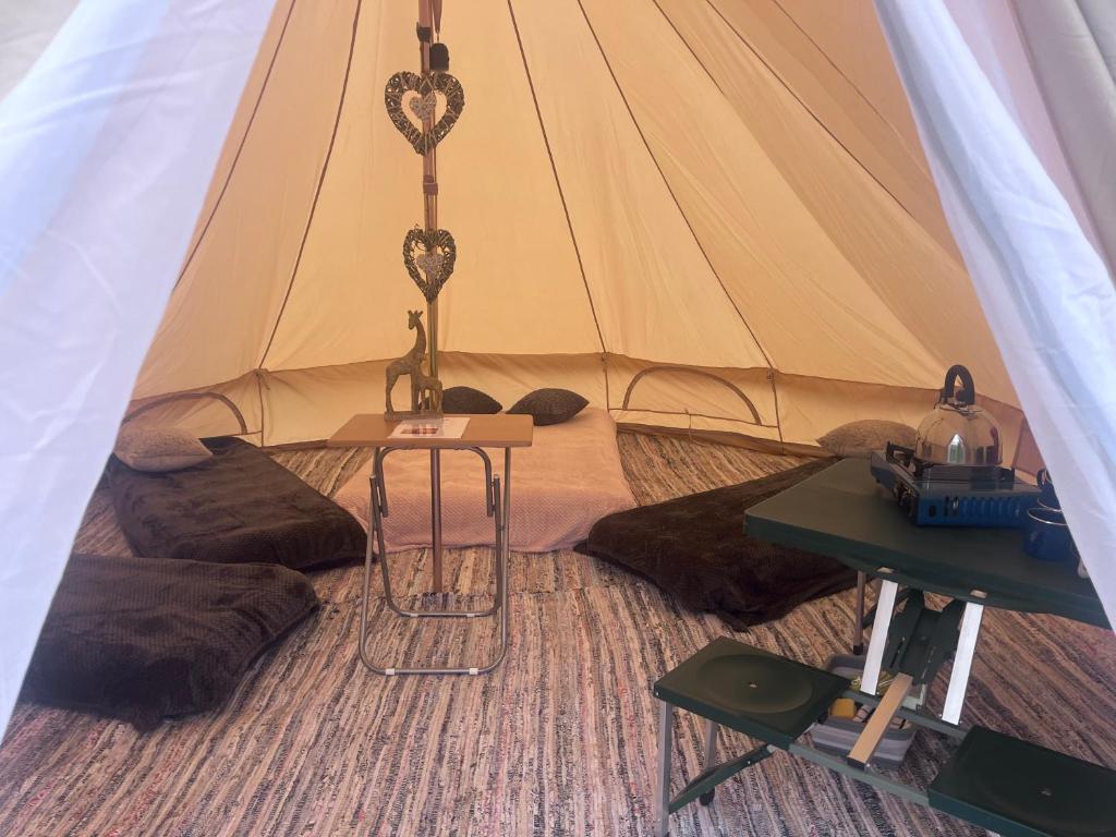 a tent with a table in front of it at Gwens Garden bell tent in St. Just