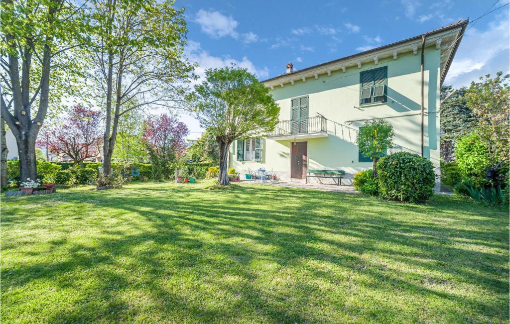 a large yard in front of a white house at Amazing Apartment In Borghetto Di Borbera - With Wifi And 2 Bedrooms in Borghetto Di Borbera