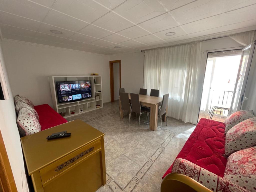 ein Wohnzimmer mit einem Sofa und einem Tisch in der Unterkunft Apartamentos Atlas Terrassa V in Terrassa