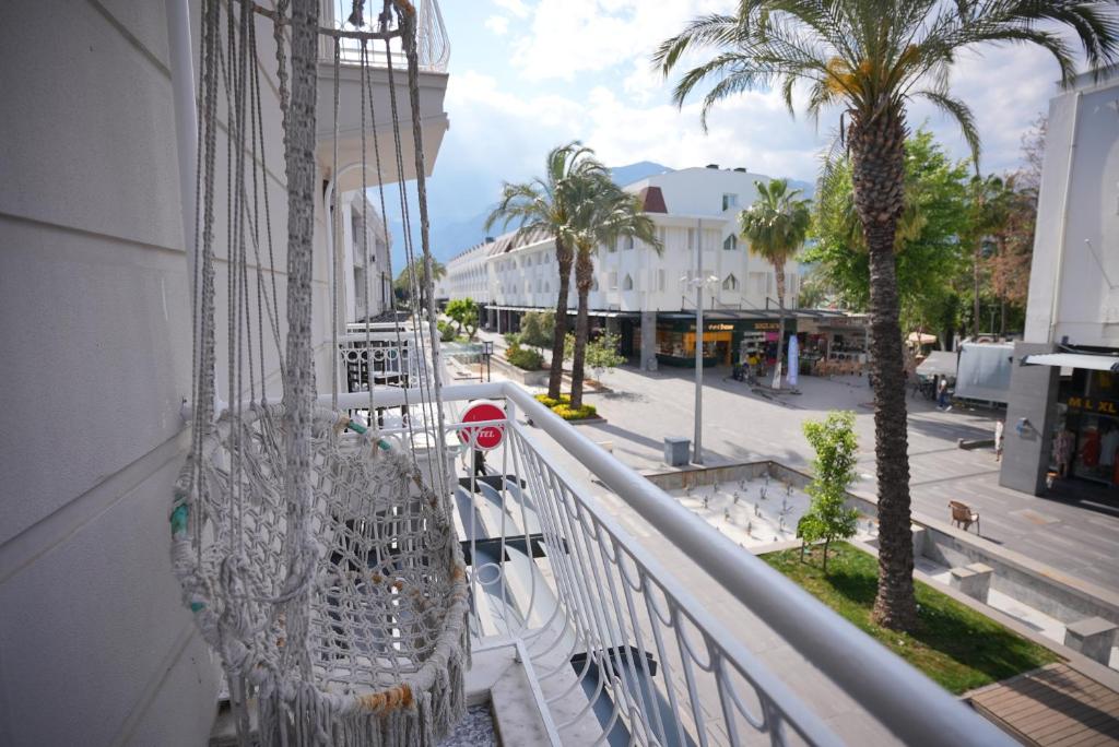 a balcony with a view of a street and palm trees at Nar 15 Boutique in Kemer