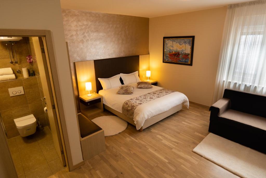 a hotel room with a bed and a bathroom at Scallop Rooms self check-in in Zadar