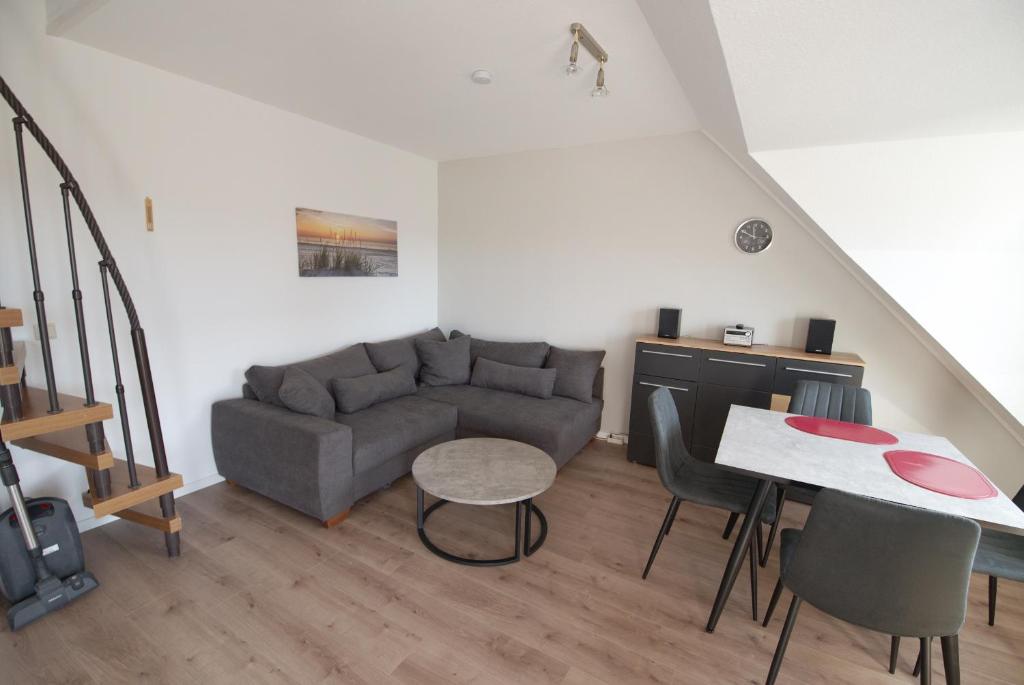 a living room with a couch and a table at Deichläufer in Dorum Neufeld