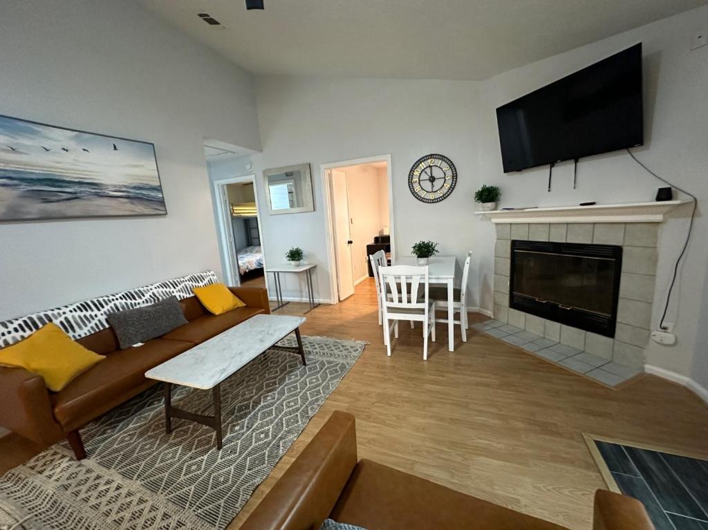 a living room with a couch and a fireplace at Beautiful House Sleeps 12 - Hot Tub - Walk to Beach in Panama City Beach