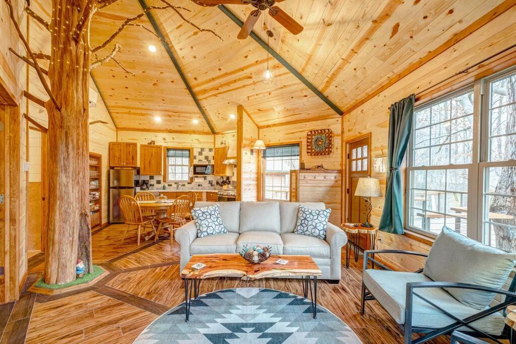 a living room with a couch and a table at Greenbrier Beechhouse Luxury Treehouse in Greenbrier