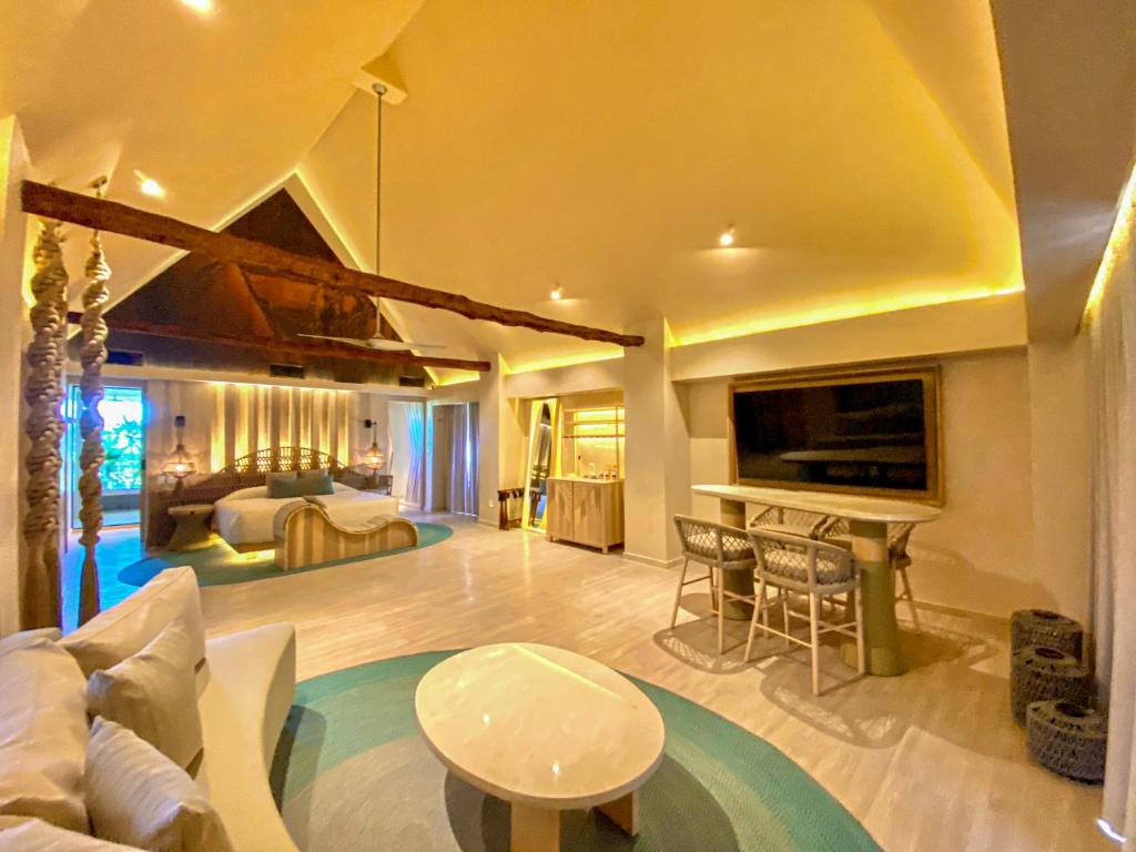 a large living room with a bed and a table at Hotel Shibari - Restaurant & Cenote Club in Tulum