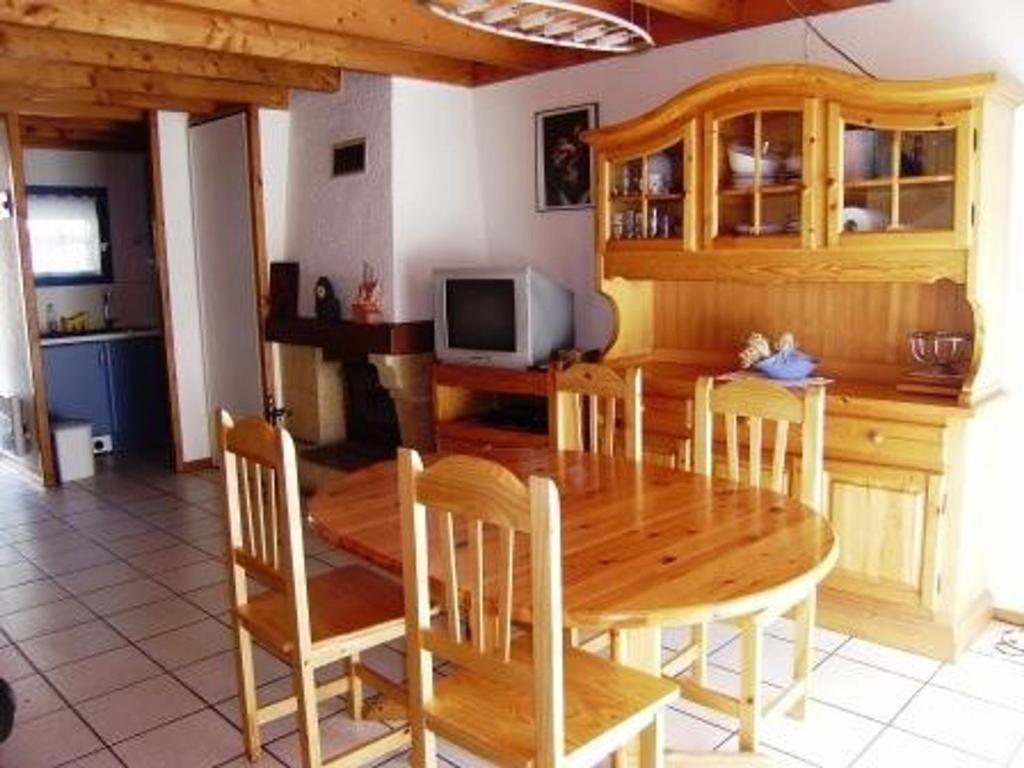 a dining room with a wooden table and chairs at Appartement Esquièze-Sère, 3 pièces, 7 personnes - FR-1-402-87 in Esquièze - Sère