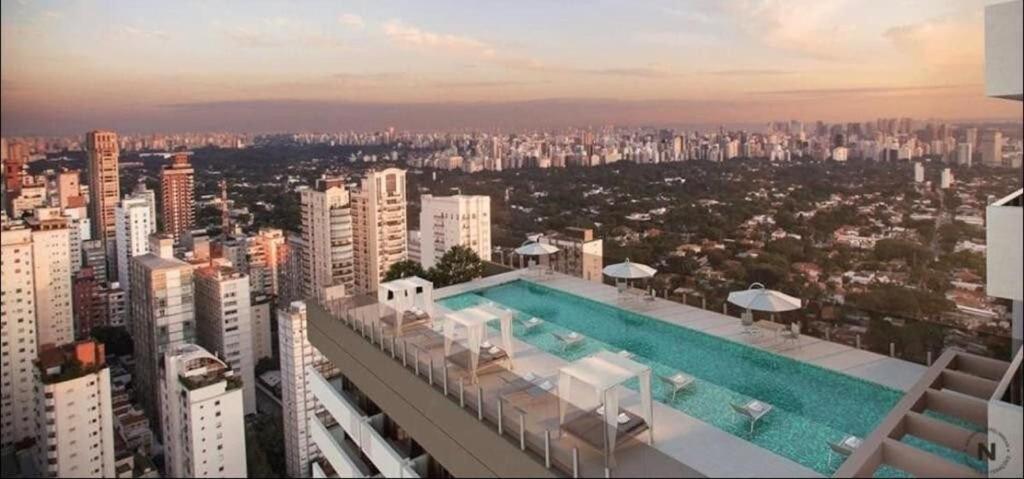 una piscina en la parte superior de un edificio de una ciudad en Estúdio com garagem no Bairro do Jardins, en São Paulo