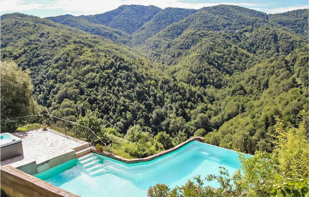 a swimming pool in the middle of a mountain at Lovely Apartment In Carcheto Brustico With Outdoor Swimming Pool in Carcheto