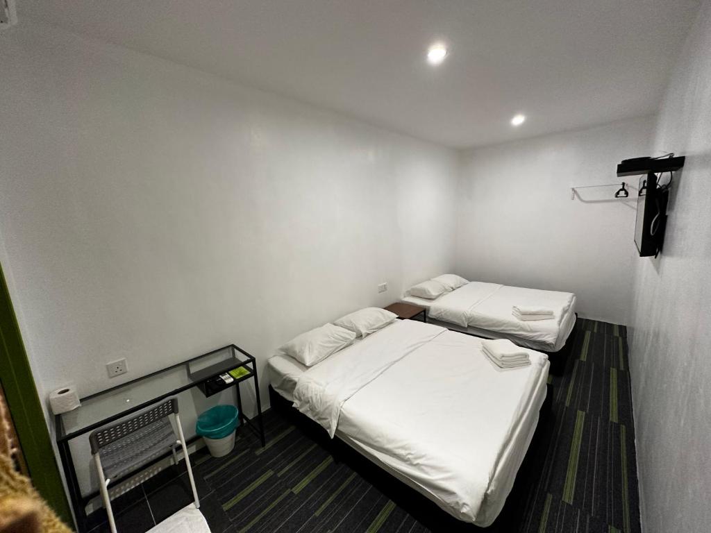 Postel nebo postele na pokoji v ubytování Olive Bedz Hotel
