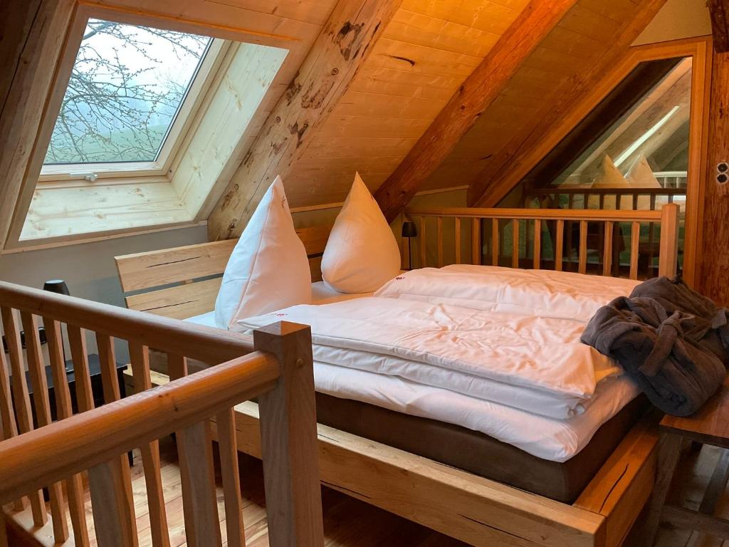 a bed in the attic of a log cabin at Blockhaus PanHütte in Braunlage
