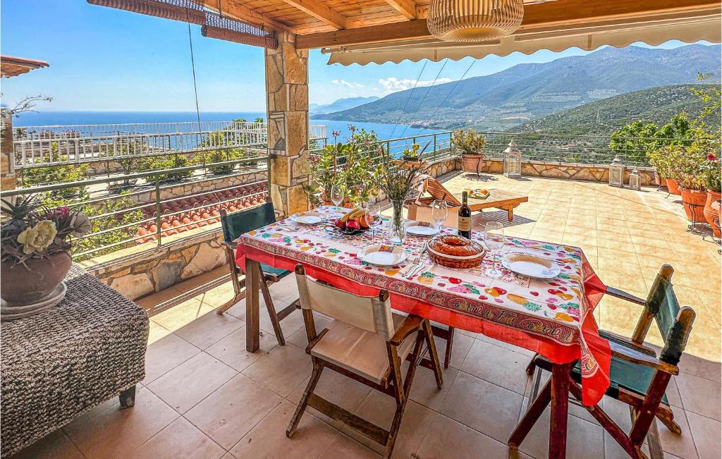 a table on a balcony with a view of the ocean at 4 Bedroom Lovely Home In Xiropigado in Xiropigado