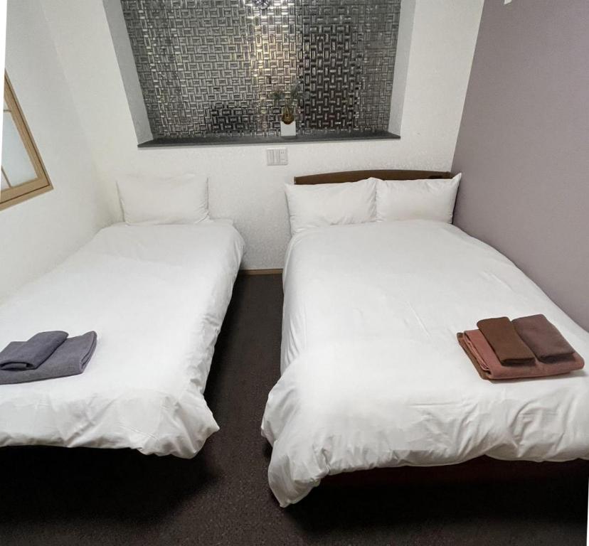 Postel nebo postele na pokoji v ubytování Allcomein Hotel Akihabara
