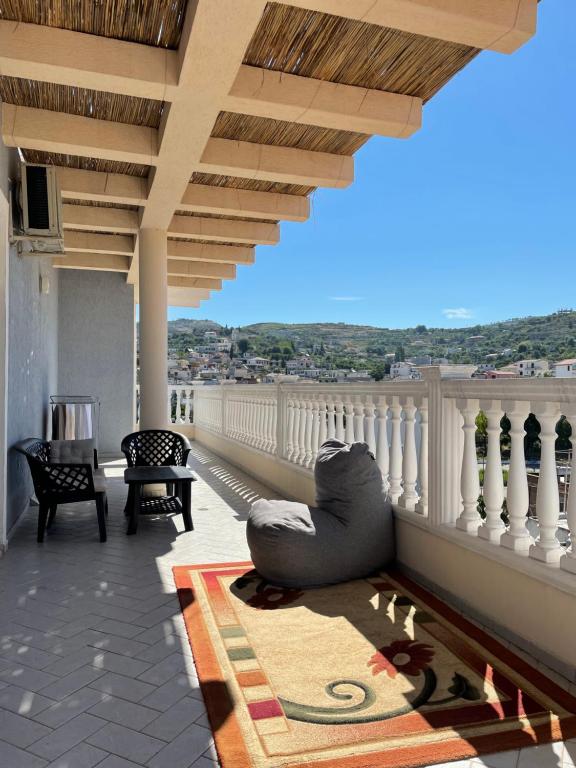 a living room with a couch on a balcony at Apartament Real Vlore in Vlorë