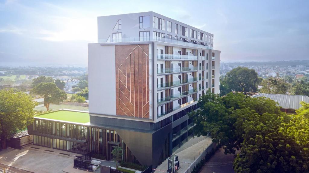 a tall white building with a wooden roof at The Lennox Luxury Apartment in Accra