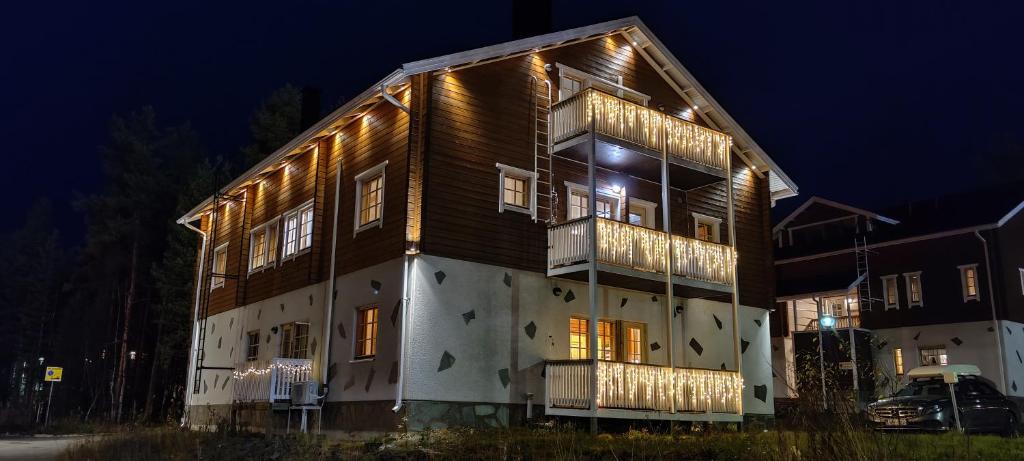 a large building with lights on it at night at Levillenet Levi centre chalets in Levi