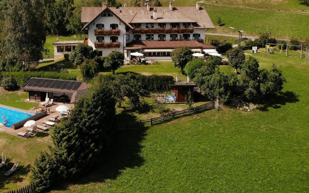 an aerial view of a large house with a swimming pool at Apparthotel Maier in Soprabolzano