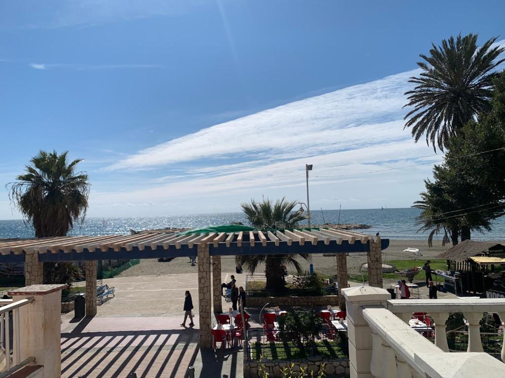 Blick auf einen Strand mit einem Pavillon und das Meer in der Unterkunft Calle Quitapenas 37 in Málaga