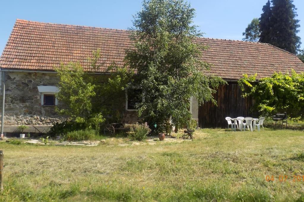 a house with a table and chairs in front of it at ROSE COTTAGE (sleeps 4) in Chlum u Třeboně