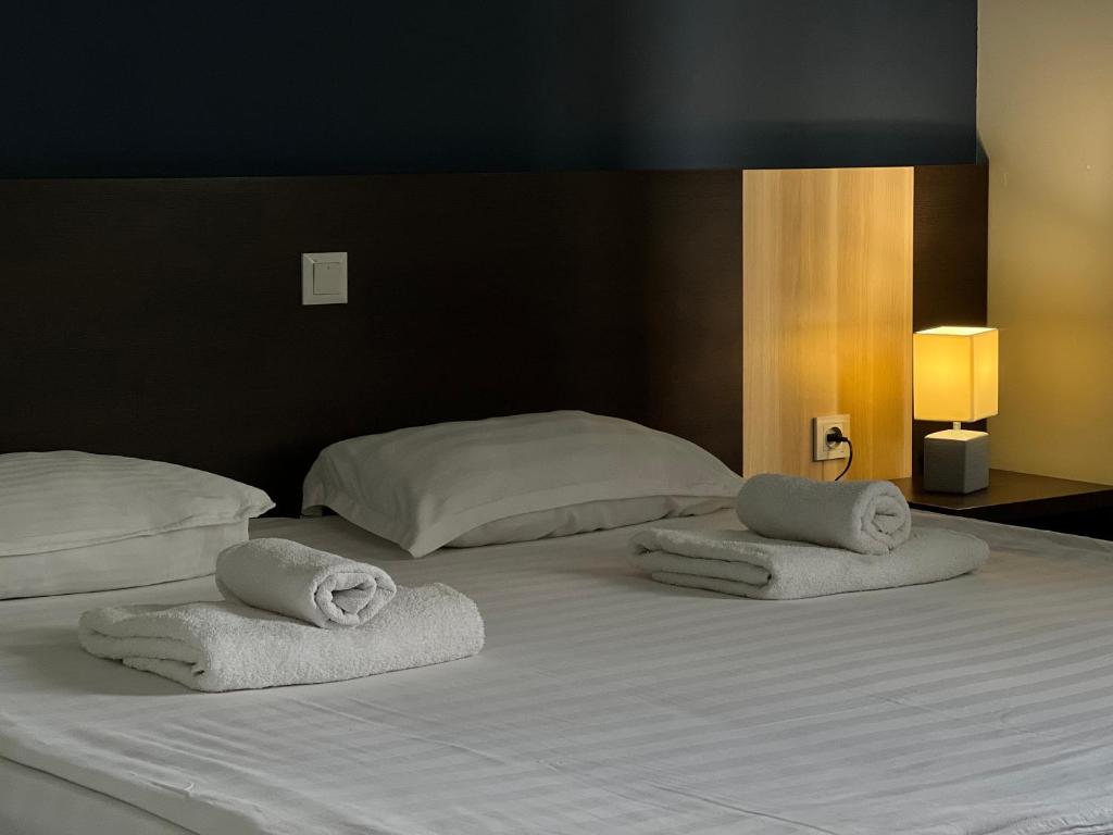 a bedroom with two beds with towels on them at TourAsia Hotel in Bishkek