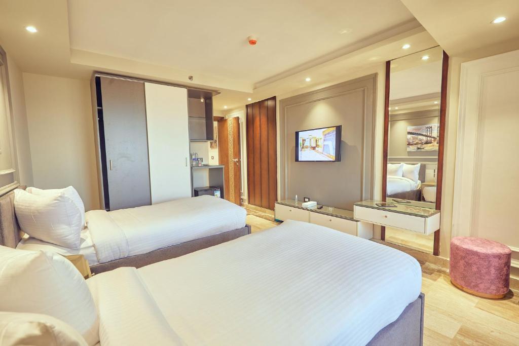 A bed or beds in a room at Grand Hotel Port Said
