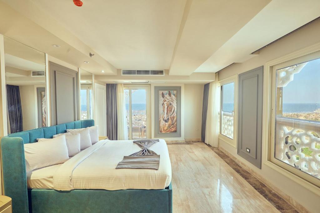 A bed or beds in a room at Grand Hotel Port Said