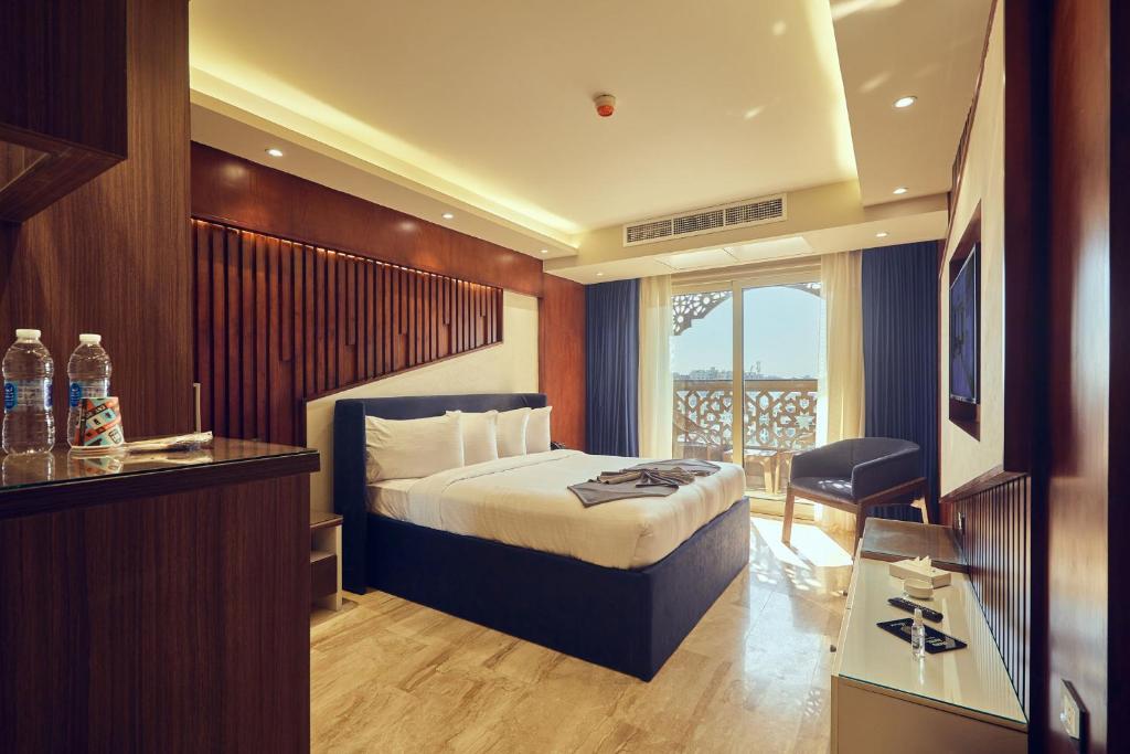 A bed or beds in a room at Grand Hotel Port Said