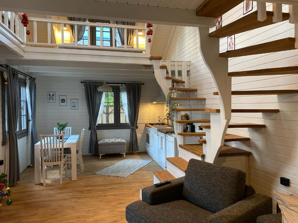 a living room with a spiral staircase in a house at Egeos Lake House in Sakarya