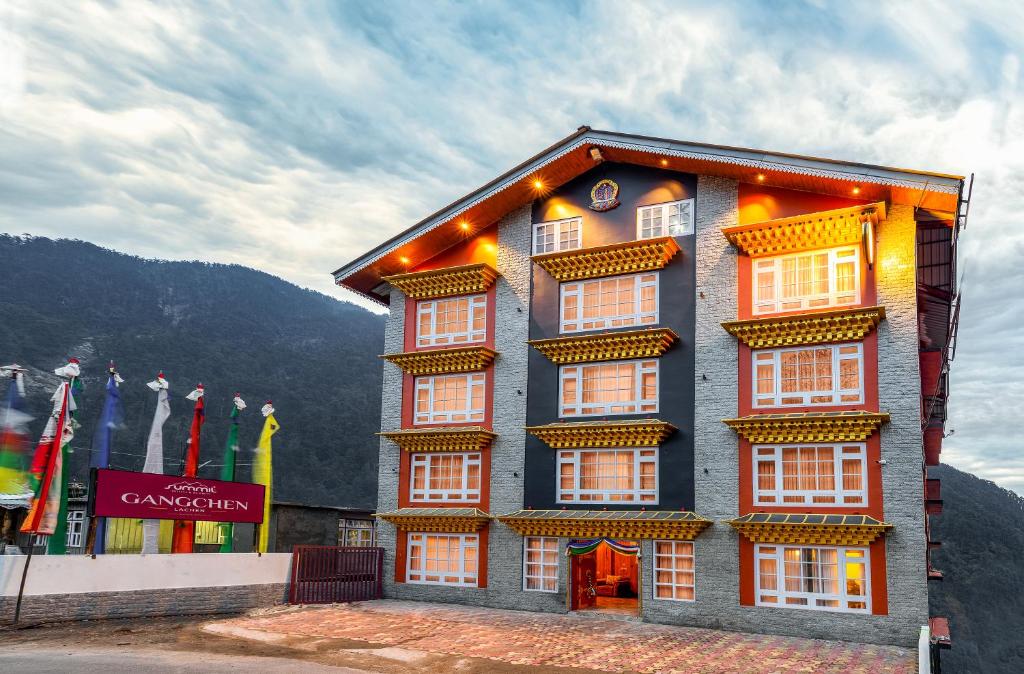a building with many windows on the side of it at Summit Gangchen Hotel in Lachen