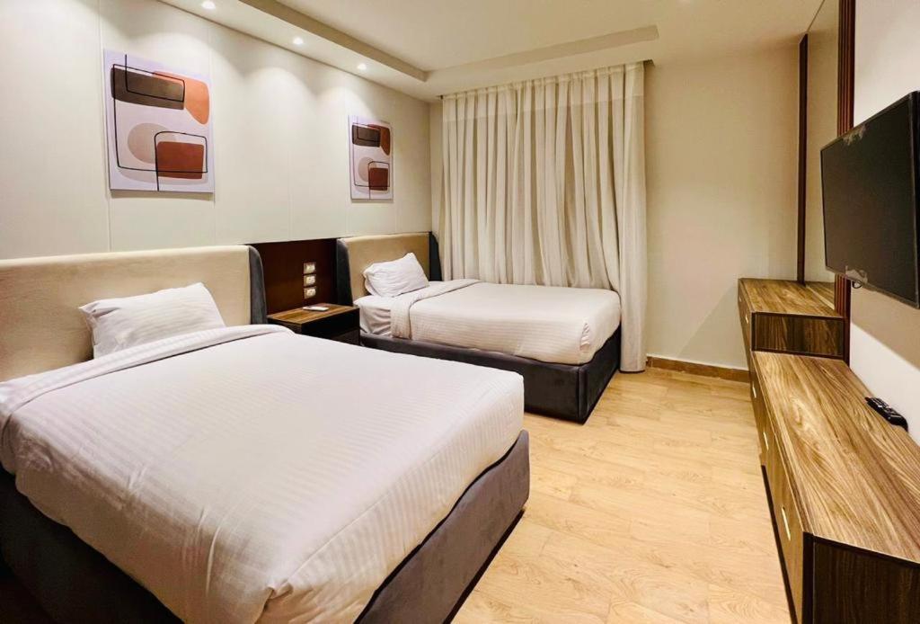 A bed or beds in a room at Grand Hotel Port Said