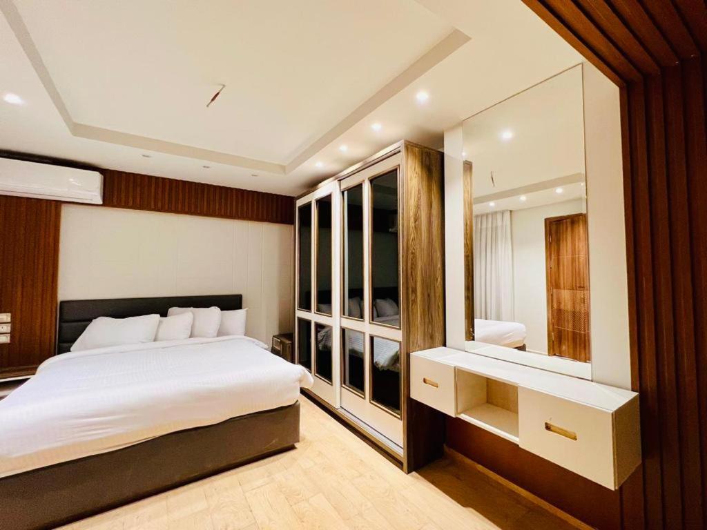 A bed or beds in a room at Grand Hotel Port Said