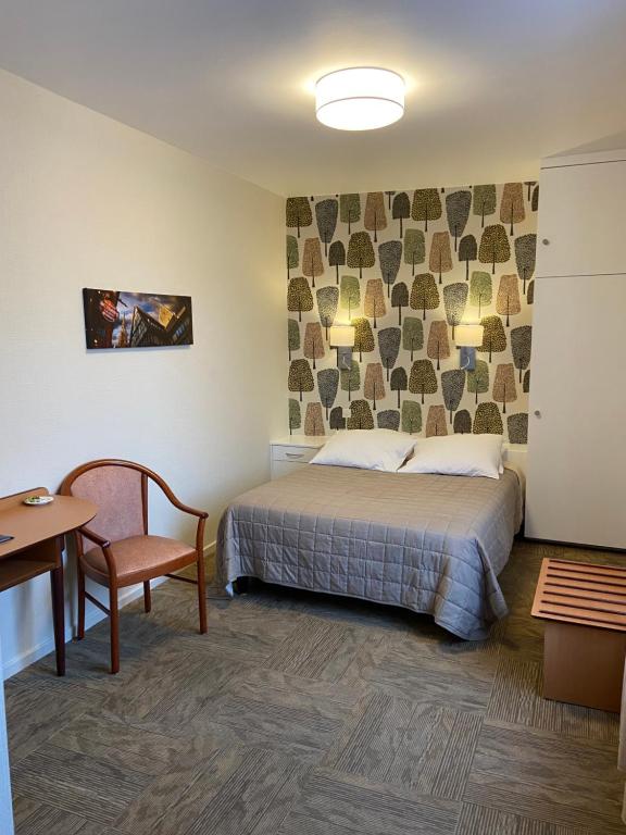 Postel nebo postele na pokoji v ubytování Hôtel Bar Des Vosges