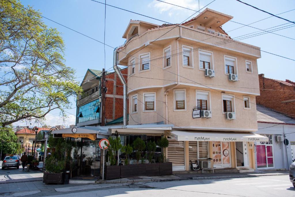a large building on the corner of a street at Gurman in Strumica