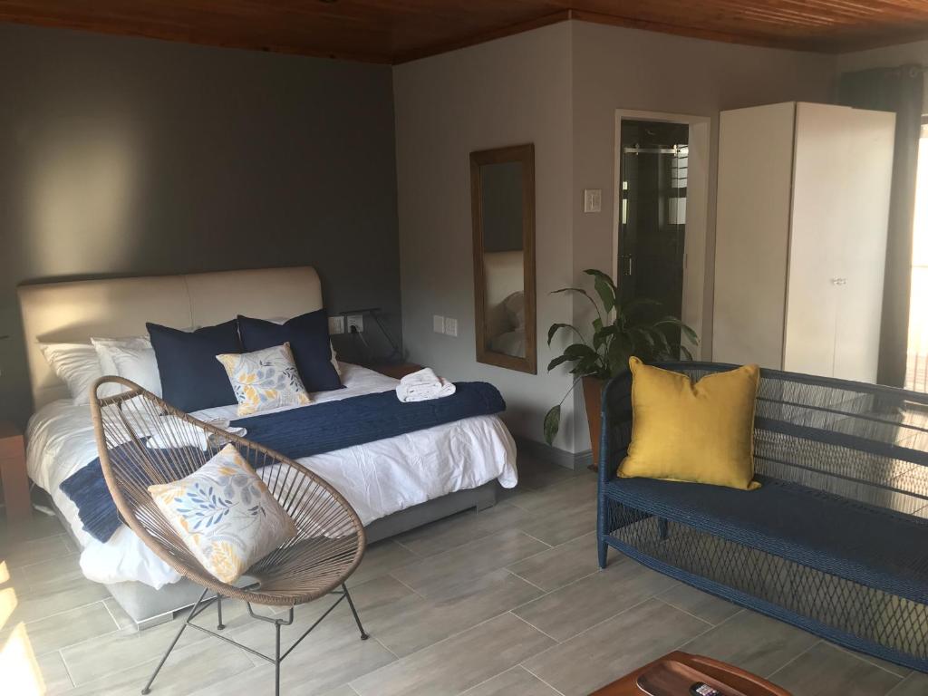 a bedroom with a bed and a chair at Blue Lotus Guest House Pta East-Solar power in Pretoria