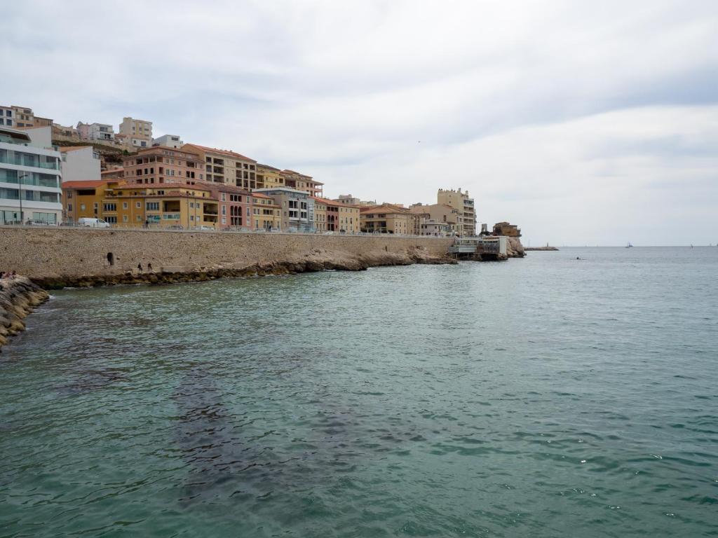 zbiornik wodny z budynkami na brzegu w obiekcie Appartement Architecte Catalans- Bord de mer w Marsylii