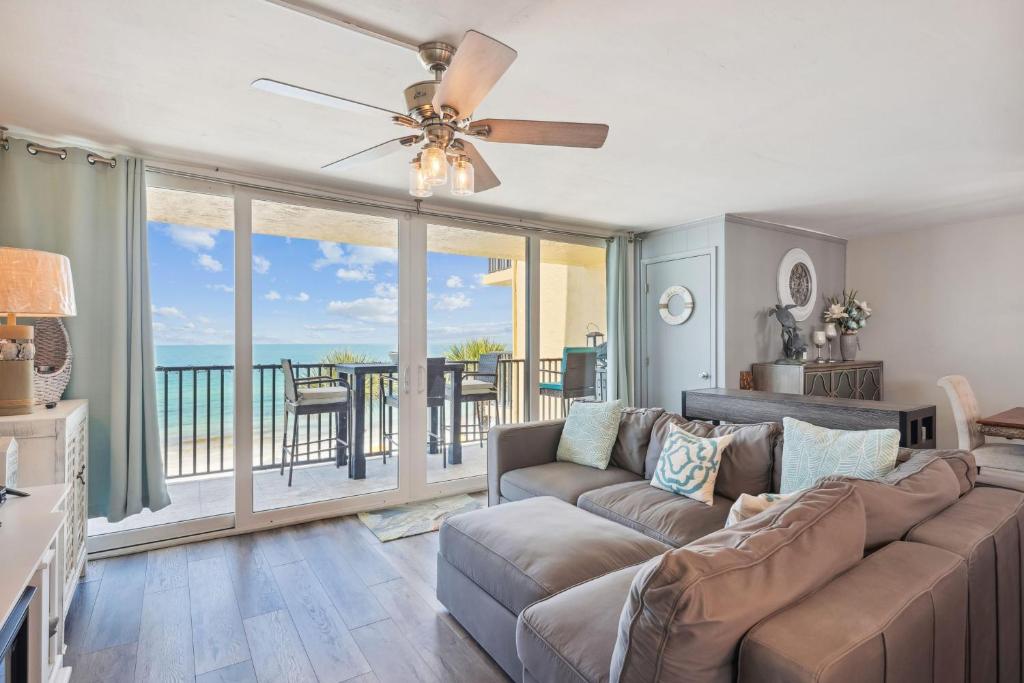 a living room with a couch and a ceiling fan at Trillium 3A - Premier in St Pete Beach