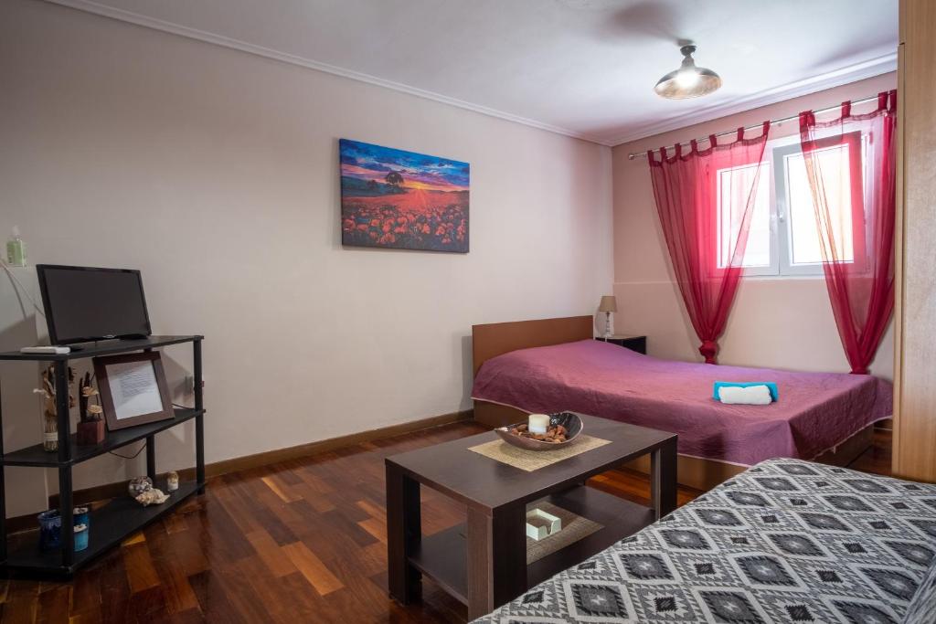 a living room with two beds and a table at James Room in Samos