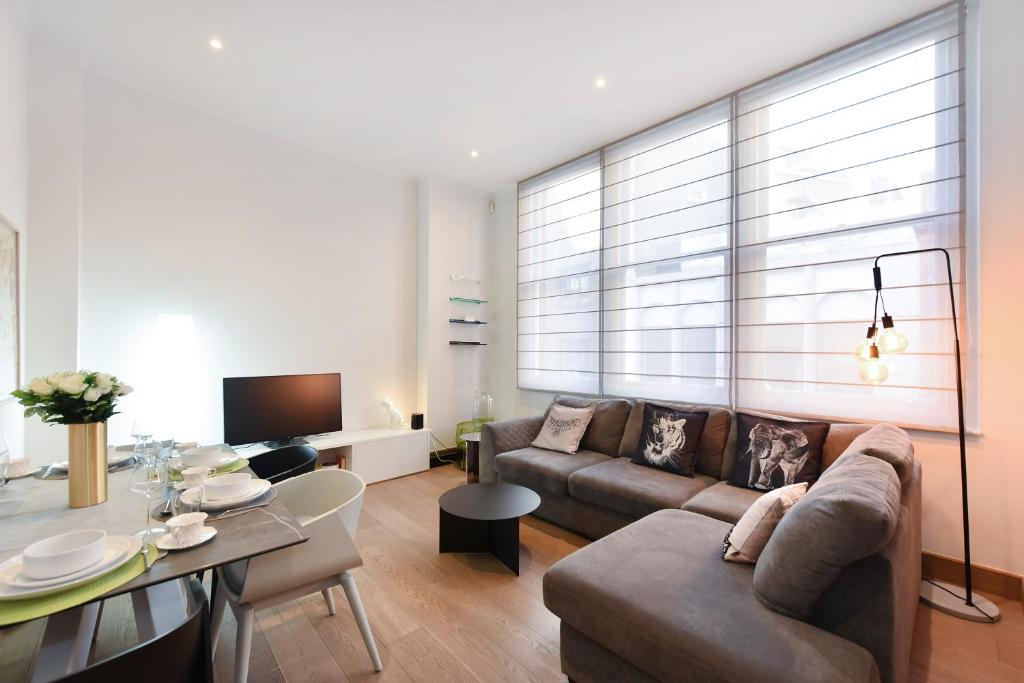a living room with a couch and a table at London Choice Apartments - Covent Garden - Leicester Square in London