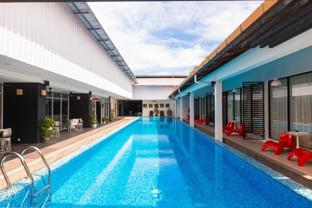 a swimming pool in the middle of a building at The Villa Langkawi in Pantai Cenang