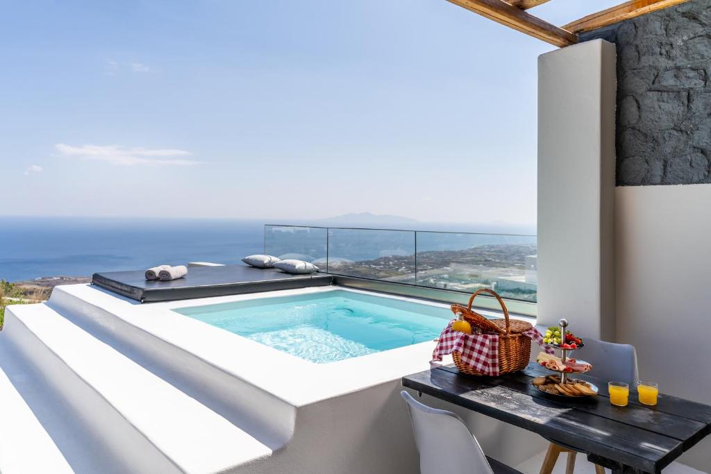a swimming pool on the balcony of a house at Abrazo Villas in Imerovigli