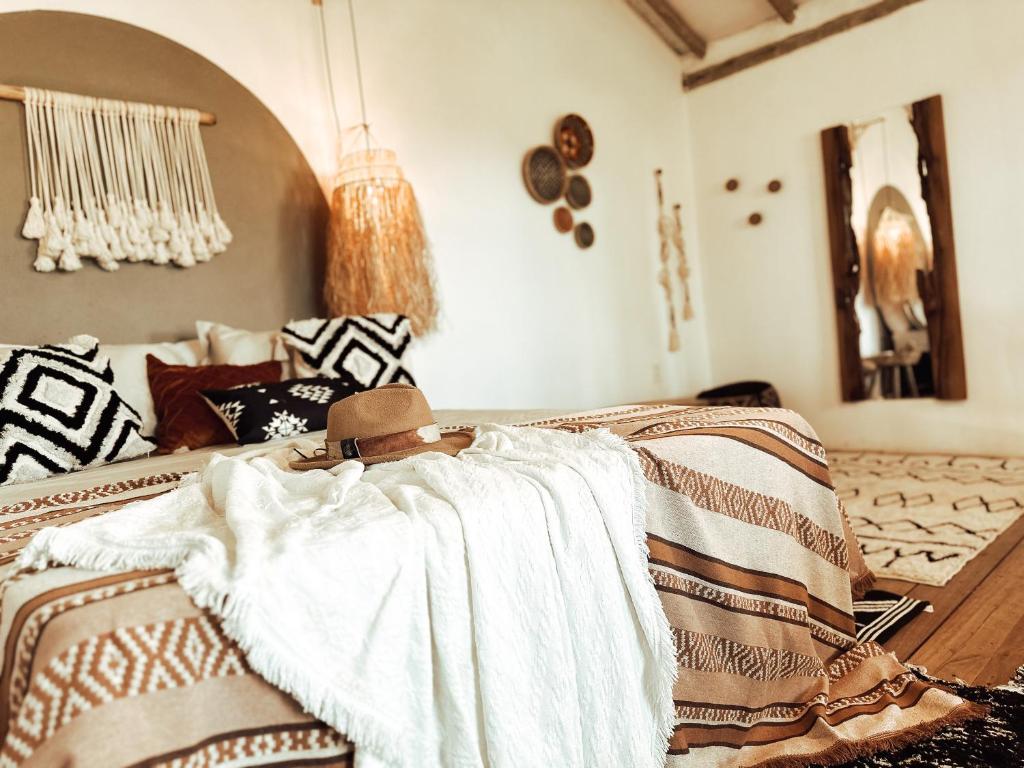 a bedroom with a bed with a blanket on it at CASA MUNDI in Caraíva