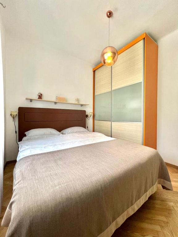 a bedroom with a large bed with a large window at Apartment Kiki in Kotor
